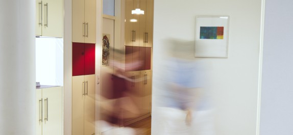 Praxismitarbeiter laufen durch die Zahnarztpraxis